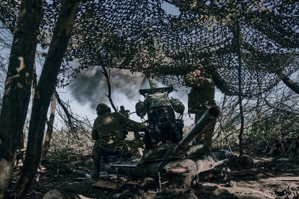 Ukrainian soldiers fire a cannon near Bakhmut