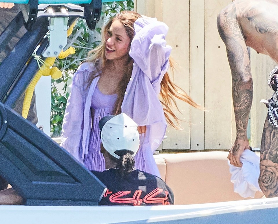 The singer runs her hands through her hair as she joins the boat ride