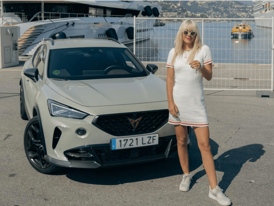 The presenter showed off her toned physique in a figure-hugging white knitted mini shirt dress and white Nike trainers