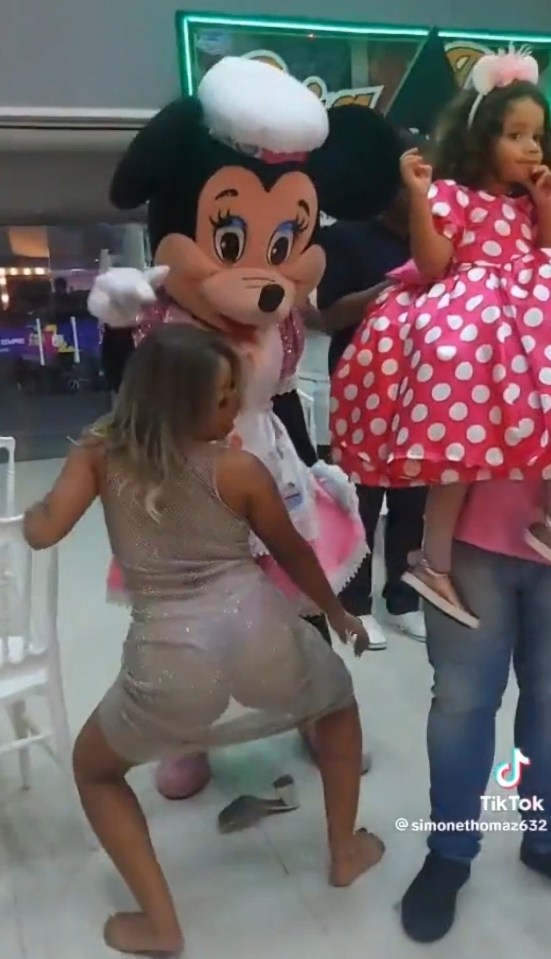 A Minnie Mouse entertainer awkwardly tried to join in the routine