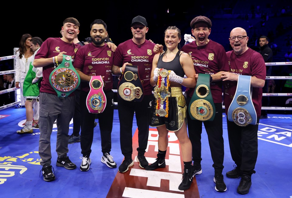 Chantelle Cameron poses with her belts and team