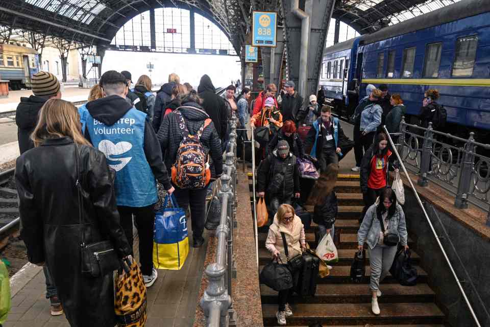 Evacuees from the Zaporizhzhia region are led on a train to take them further into Russian-controlled territory