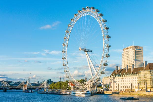 a large ferris wheel is in the middle of a body of water