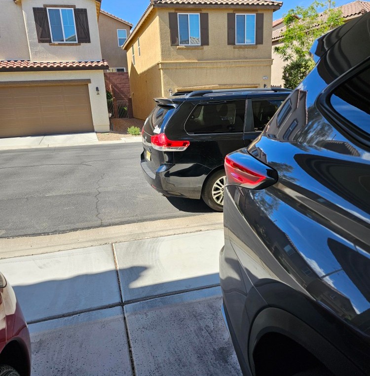 A woman claims that their neighbour keeps parking in front of their garage