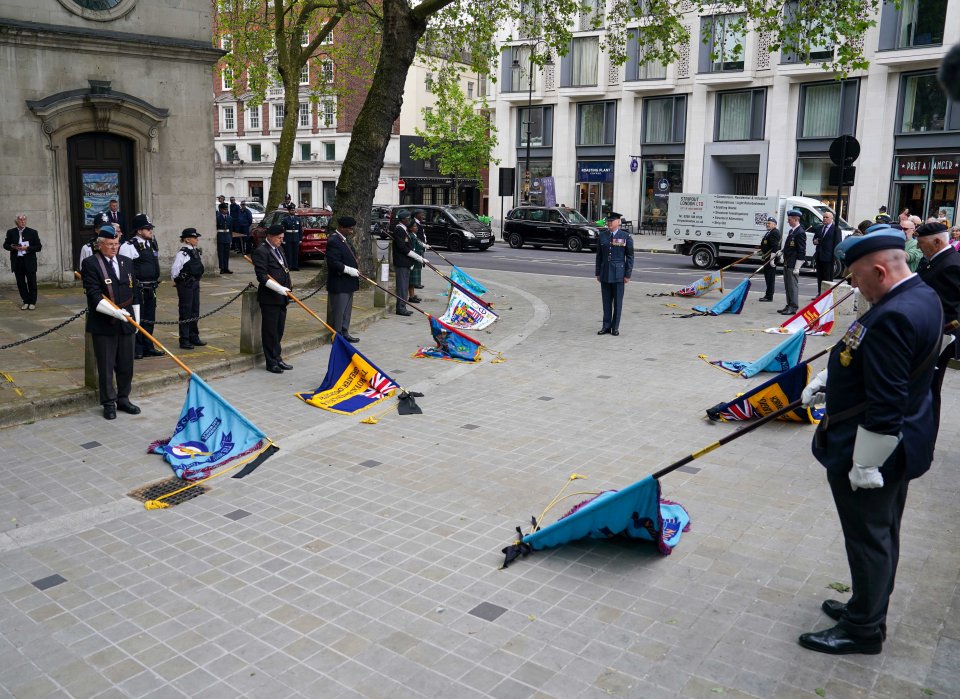 Flags are lowered as Peter's cortege passes on route to the church