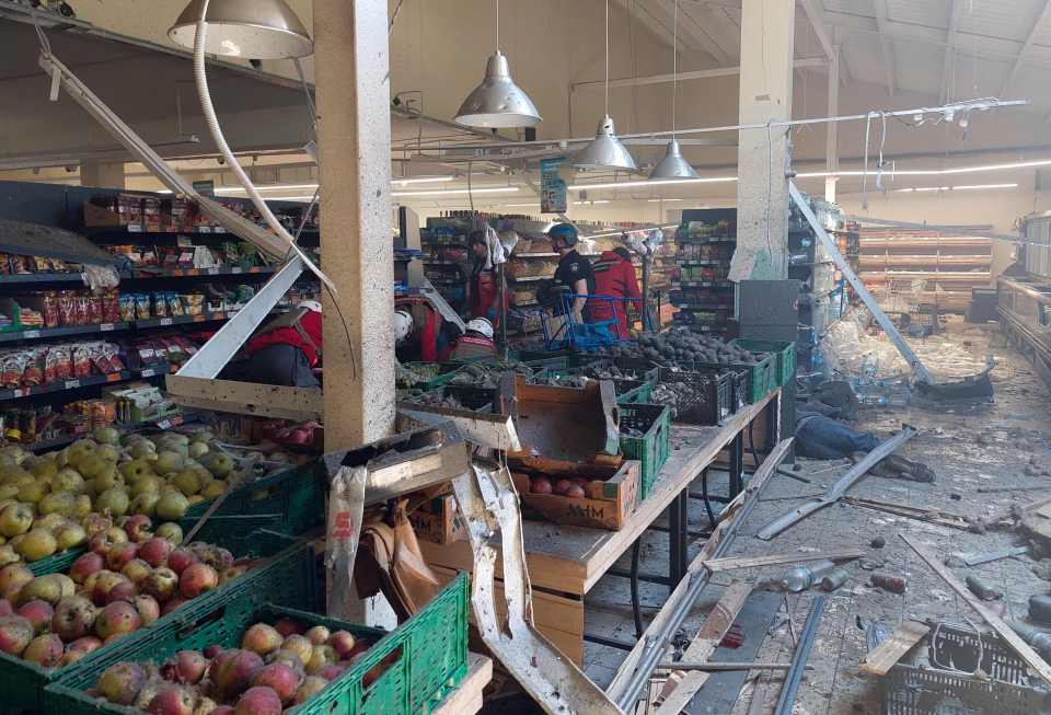 Bodies lie on the aisles after the store was hit by a shell