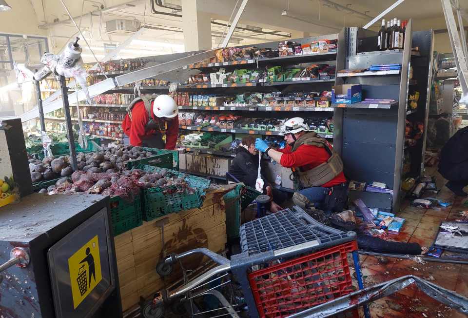 A Ukrainian civilian being treated in a supermarket