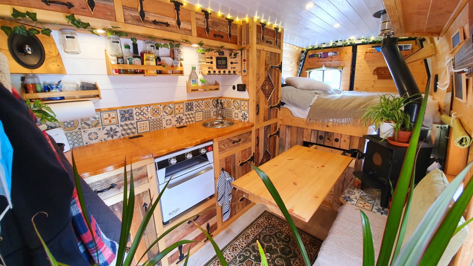 He used timber frames and pieces of pallet wood to transform the van's interior