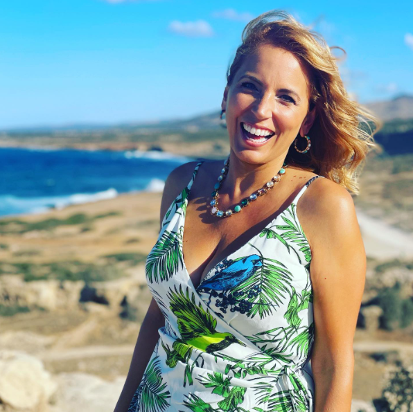 Jasmine Harman wowed fans as she wore posed in a tropical dress with a plunging neckline