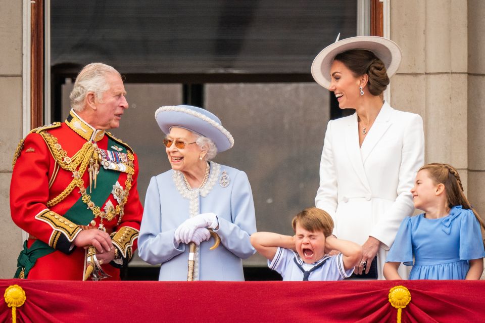 King Charles III enjoying grandfatherly duties with Prince Louis and Princess Charlotte on the balcony of Buckingham Palace