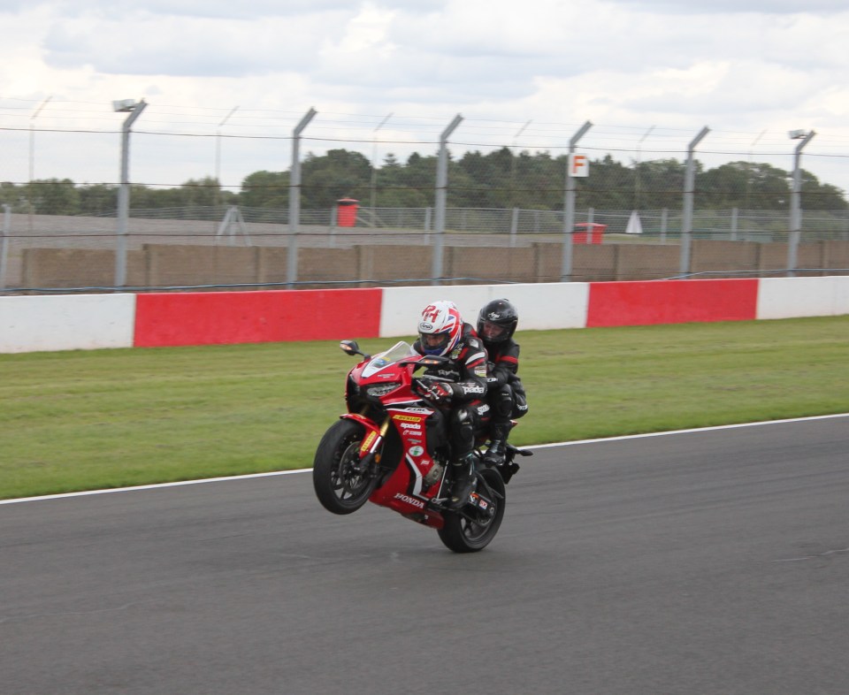 Laura at full throttle on a racing bike with Ron Haslam