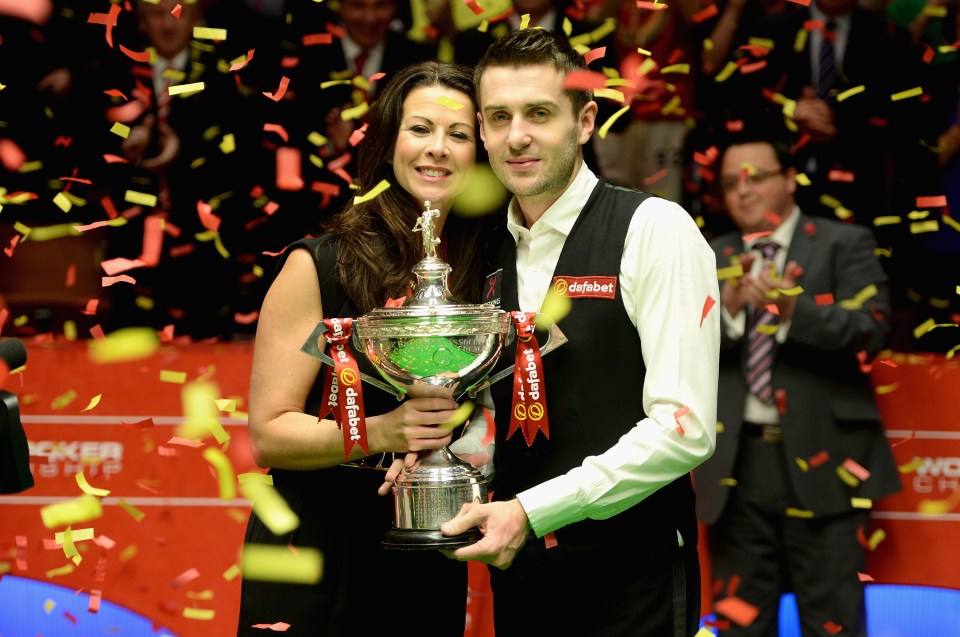 Mark Selby lifts the trophy with wife Vikki after winning the World Snooker Championship in 2014