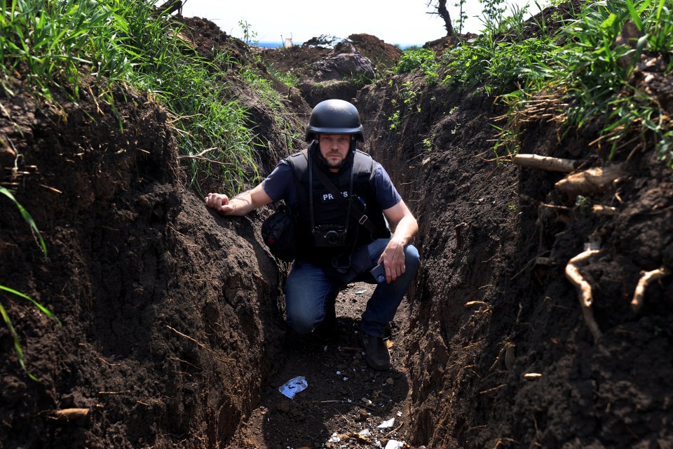 The Sun's Jerome Starkey crouches in a trench claimed by Ukraine near Bakhmut