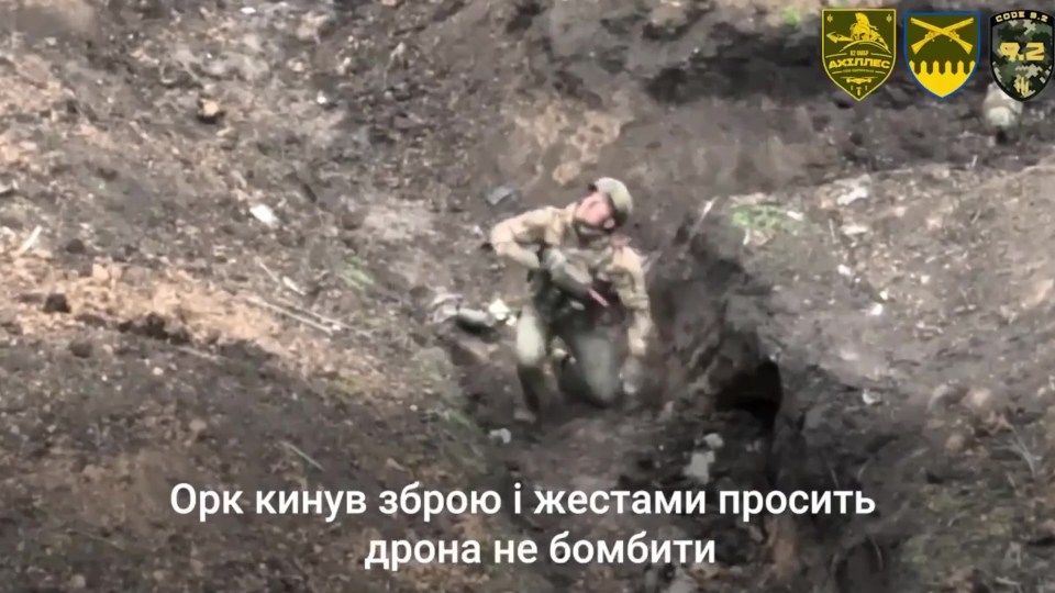 The soldier spots the drone in the sky while in a Russian trench