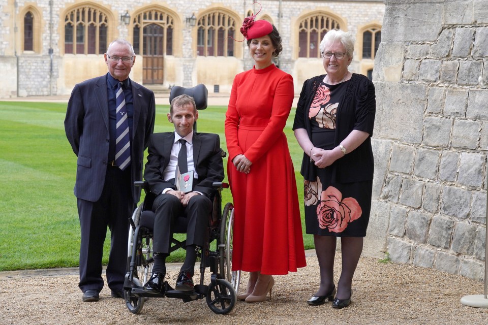 Rob with his mum and dad and wife Lindsey after he was made an MBE