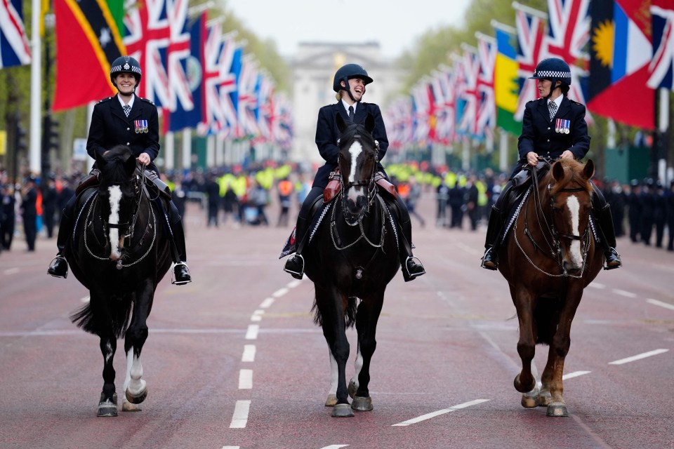 Mounted police officers ride their horses on the route of the King’s coronation