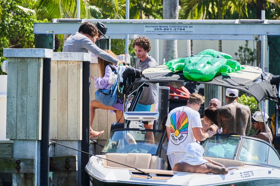 The singer climbed off the boat while Lewis stayed with his pals