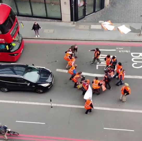 After shoving one activist to the ground, he pushed others before turning his attention to the one filming the incident