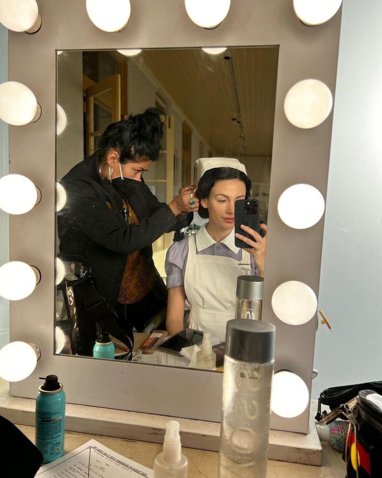 Michelle looked stunning in a mirror selfie while getting her hair done in her character's costume