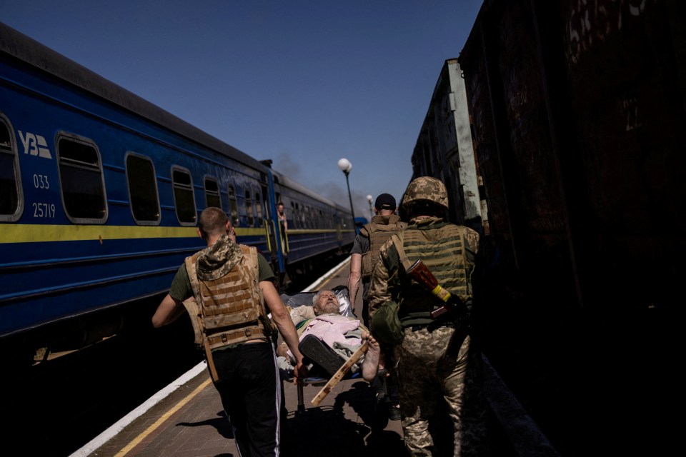 A survivor of the station attack being stretchered away