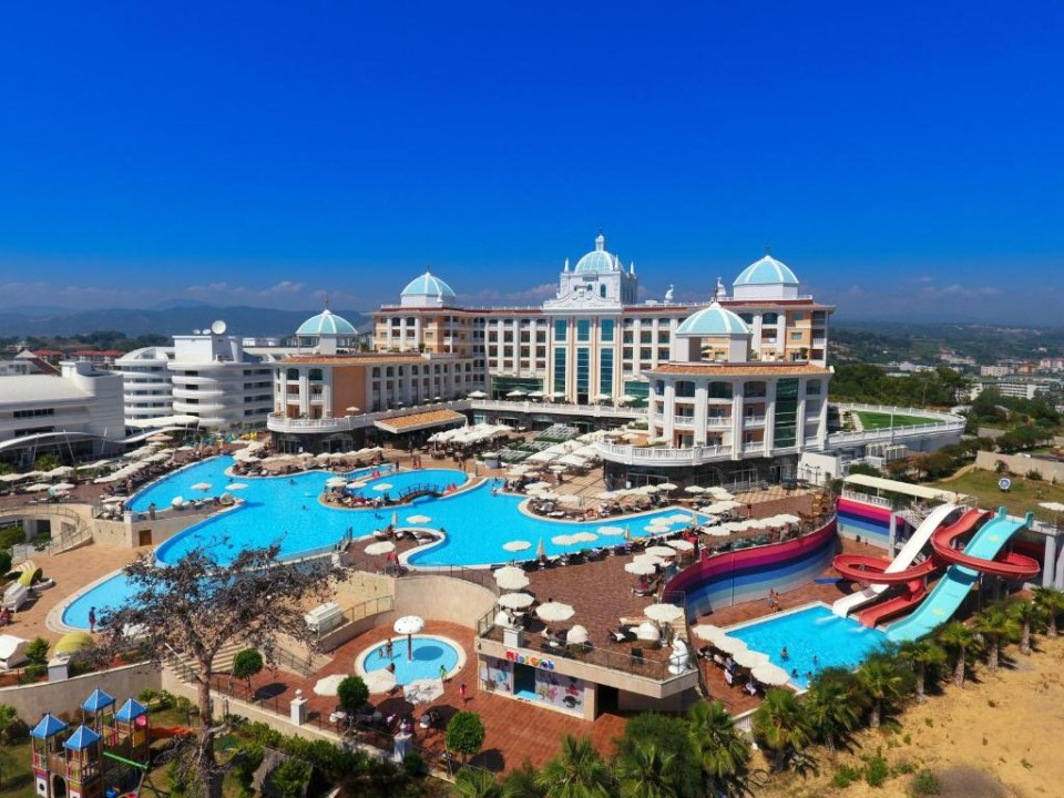 an aerial view of a large hotel with swimming pools and waterslides