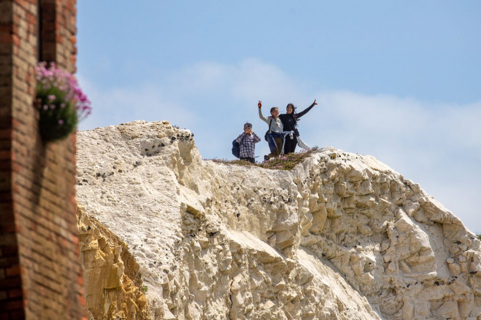 A group of pals were also photographed on the cliff-edge, which is prone to rock falls