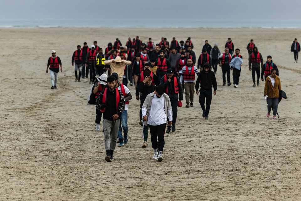 Migrants return inland after being prevented from boarding smugglers' boats by French National Police