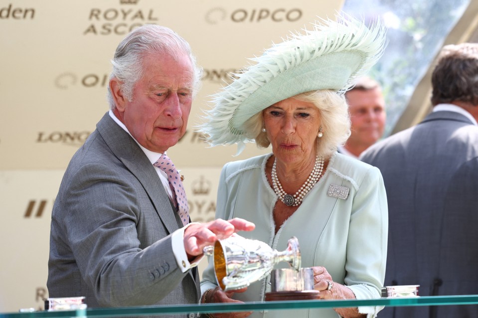 Camilla watches on as Charles drops the trophy in the winner’s enclosure