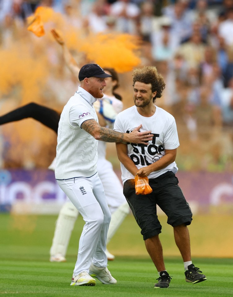 Ben Stokes grabs one of the protesters