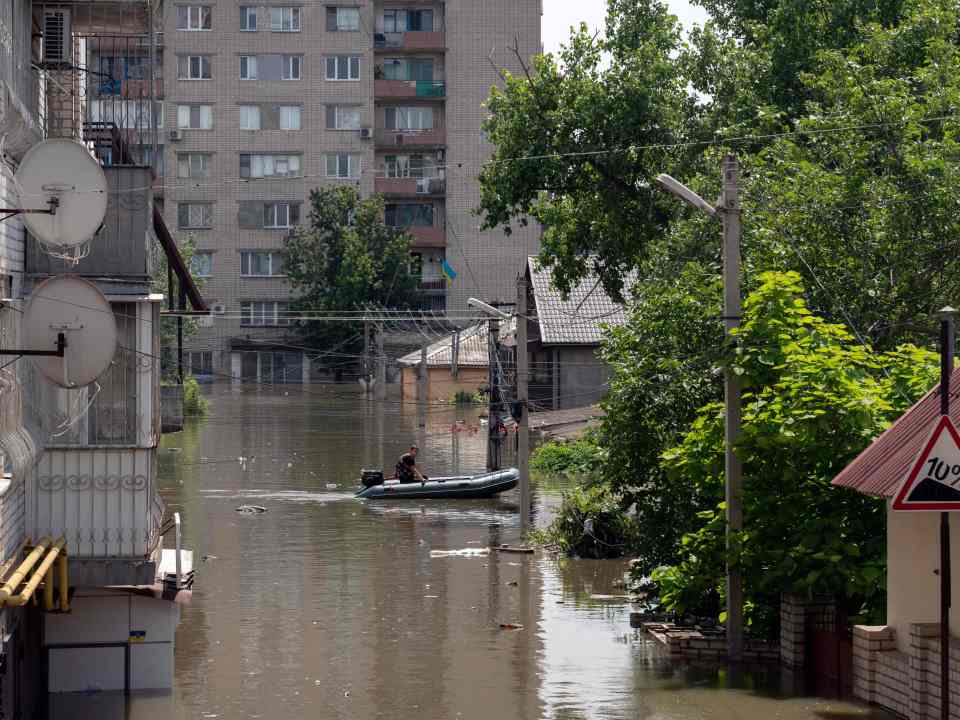 Residents are having to use boats to get around the flooded city of Kherson