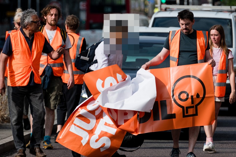 A frustrated student appeared to rip a sign from Just Stop Oil eco-idiots' hands in Stratford, London this morning