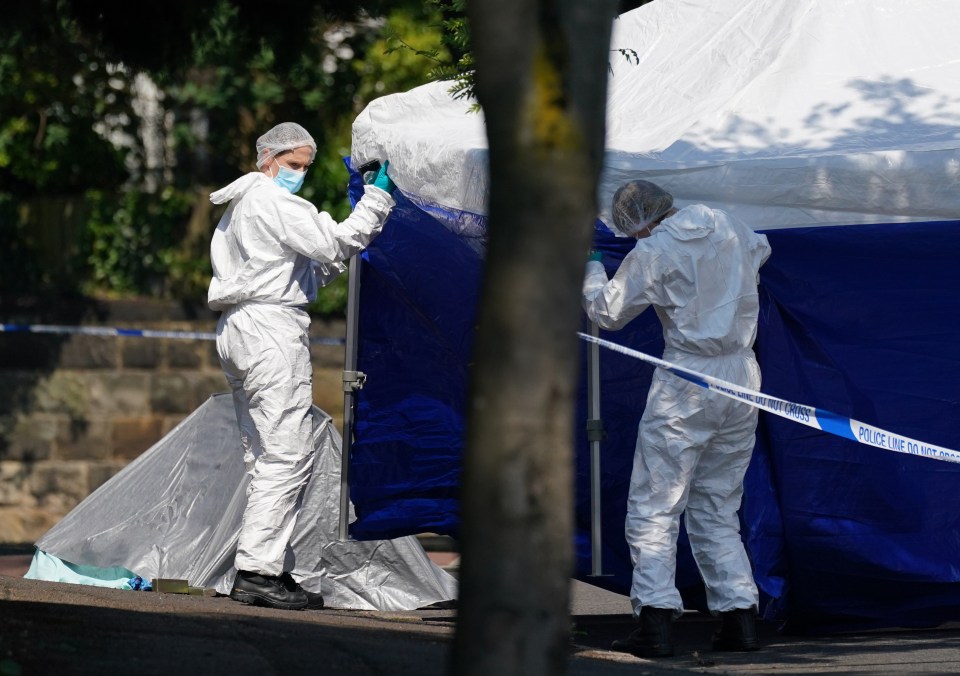 Police forensics officers erect a tent on Magdala road, Nottingham