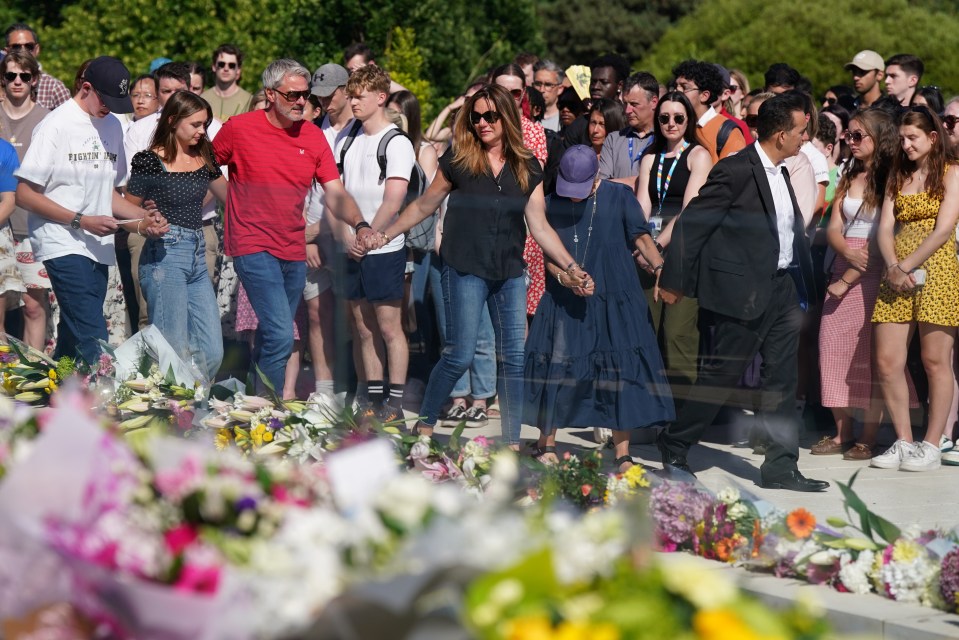 The victims’ families held hands at the vigil as they put on a united front