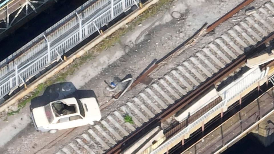 The drone footage shows a parked car filled with explosive barrels left above the section of the dam that failed