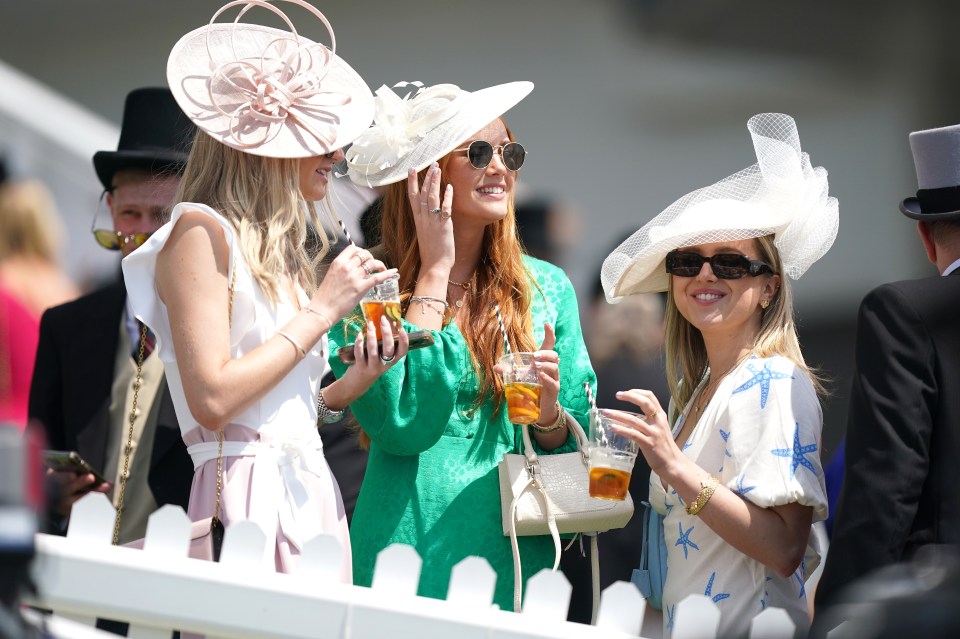 Racegoers were keen to make the most of the sun with drinks in hand