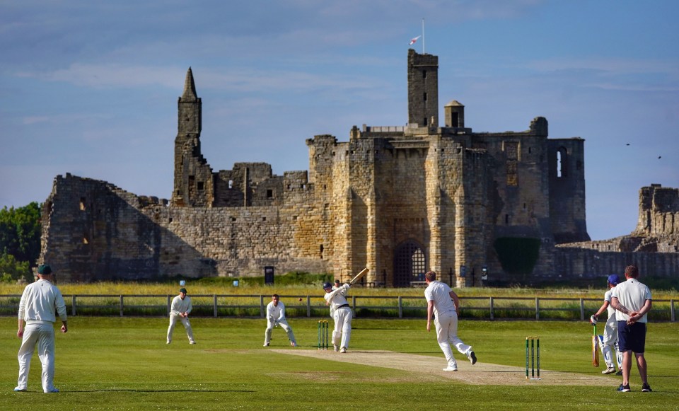 A game of cricket is played at Warkworth Cricket Club, on Saturday evening, with the ruins of medieval Warkworth Castle as a back drop, in Warkworth, Morpeth, Northumberland. Picture date: Saturday June 19, 2021. PA Photo. Photo credit should read: Owen Humphreys/PA Wire