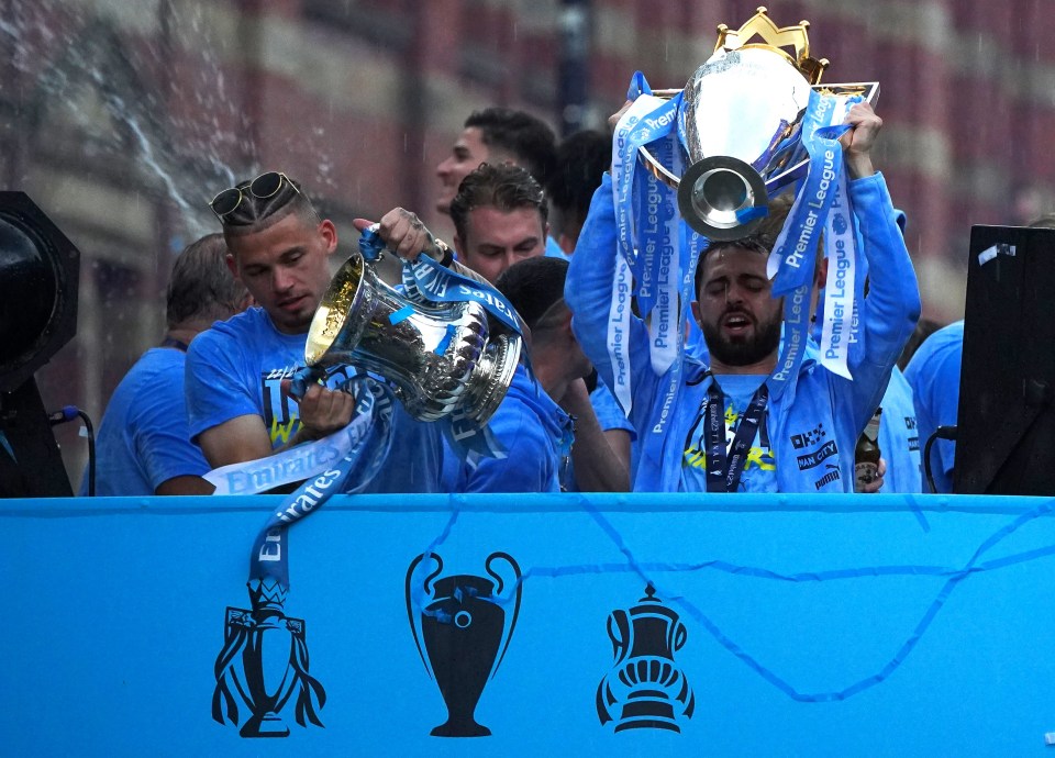 Manchester City held their trophies aloft as they celebrated the Treble