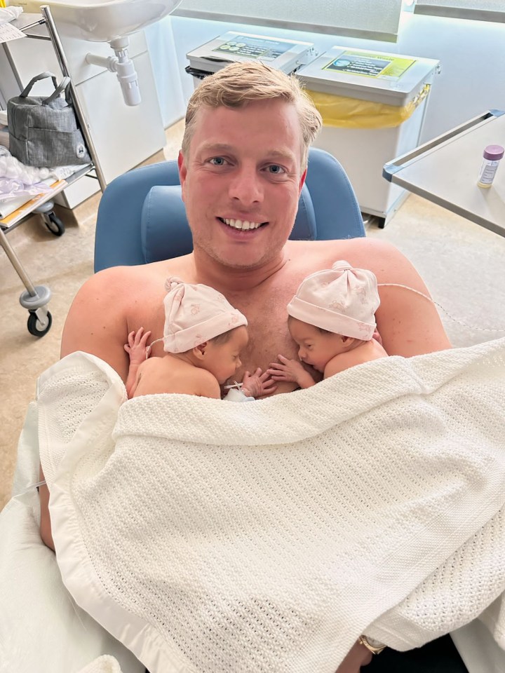 Tom Skinner with his newborn twin girls Roma and Darla