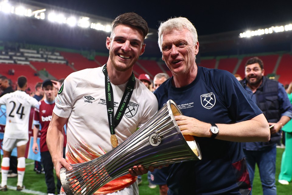 The Scot poses with the trophy and skipper Declan Rice