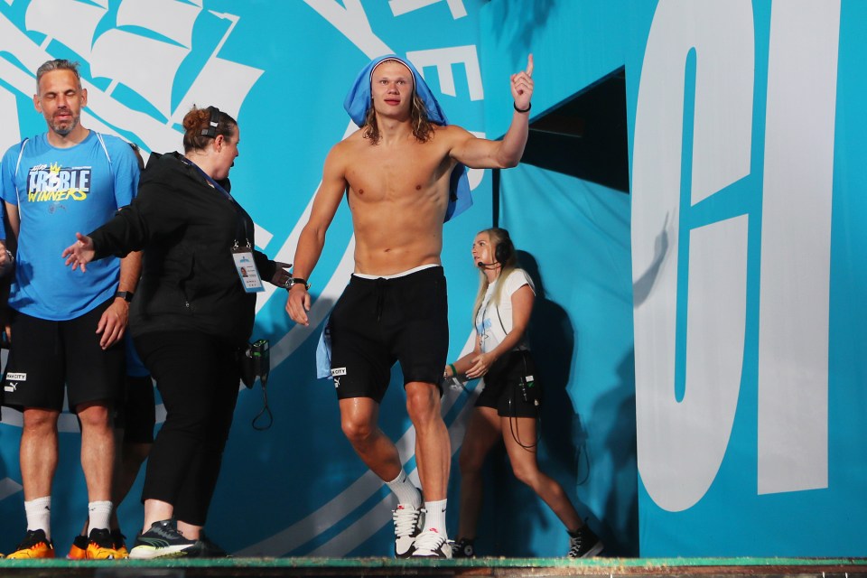 Haaland came onto the stage topless with a Man City shirt over his head