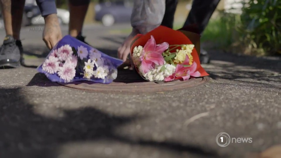 Flowers and a cross have been left at the scene