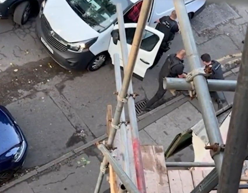 Officers arrest a man in the street following the attack