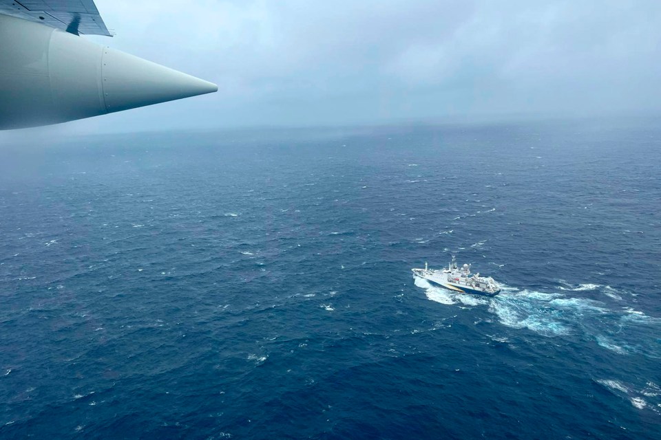 A Coast Guard HC-130 Hercules plane flies over the French vessel L’Atalante during the search