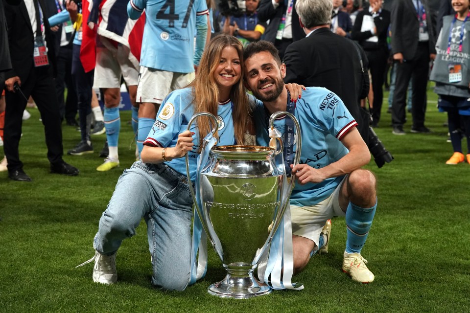 Midfielder Bernardo Silva and wife Ines Tomaz have a cuddle behind the greatest trophy in club football at the Atatuerk Olympic Stadium