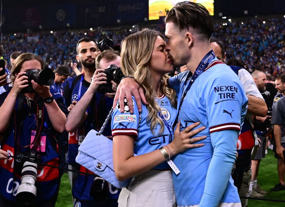 Jack Grealish enjoys his greeting from partner Sasha Attwood after Treble glory