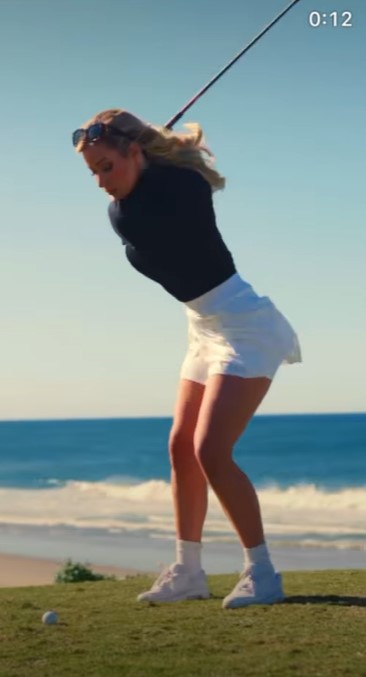 The video showed Paige playing on the course with an ocean backdrop