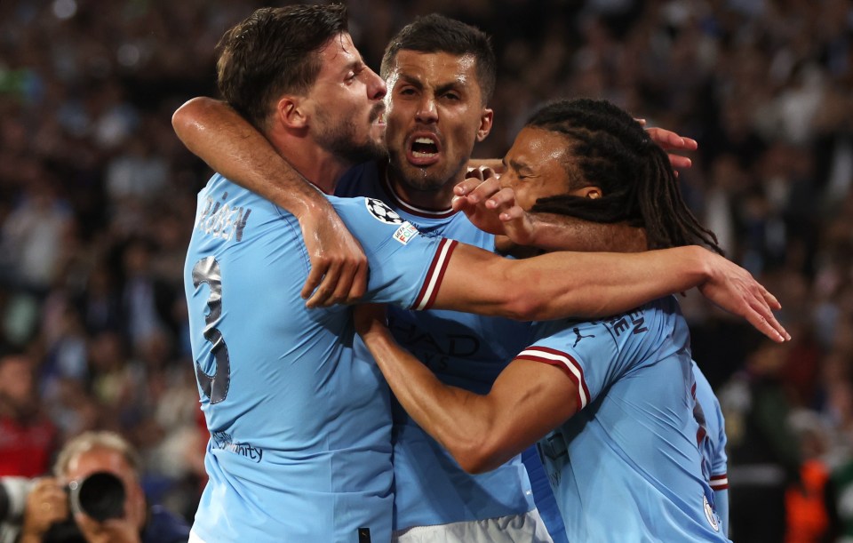 Rodri celebrates with Ruben Dias and Nathan Ake