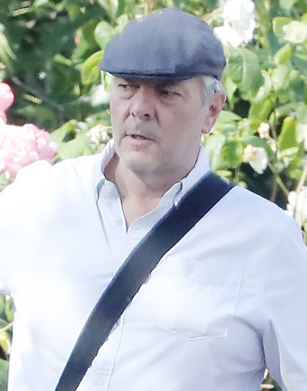 Michael pulled on a grey flat cap for a low-key look