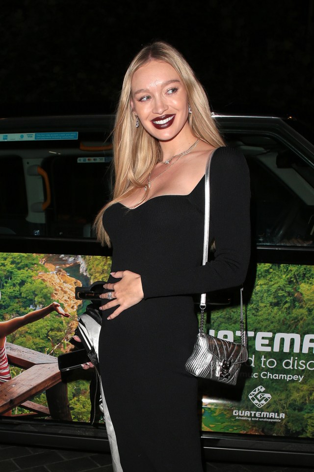 Pregnant Roxy Horner stuns as she cradles her baby bump in a tight black dress