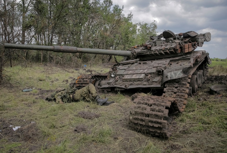 A dead Russian soldier lies beside a destroyed tank in the newly liberated village Storozheve, south-east Ukraine